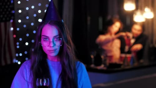 Young Woman Celebrating at Party Drinking Wine