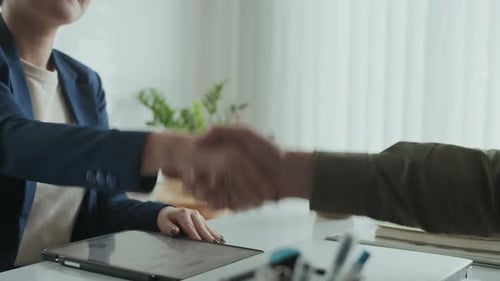 Unrecognizable Businesspeople Shaking Hands after Deal at Office