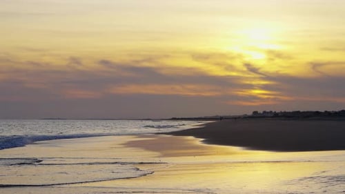 Tranquil Shoreline Bathed in Warm Hues As the Sun Sets Over the Ocean