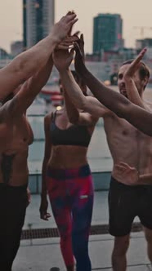 Friends High-Fiving After Workout in City