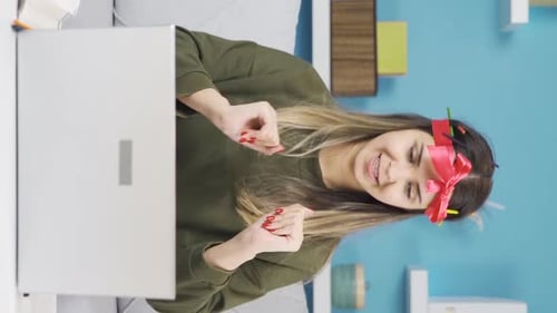 Vertical Video of Funny young girl happy studying at home.