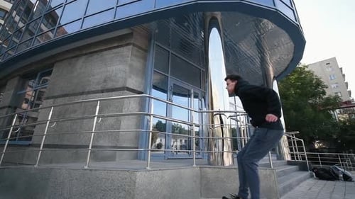 Young man running and jumping above obstacle in the city at daytime