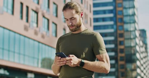 Man Using Smartphone in City
