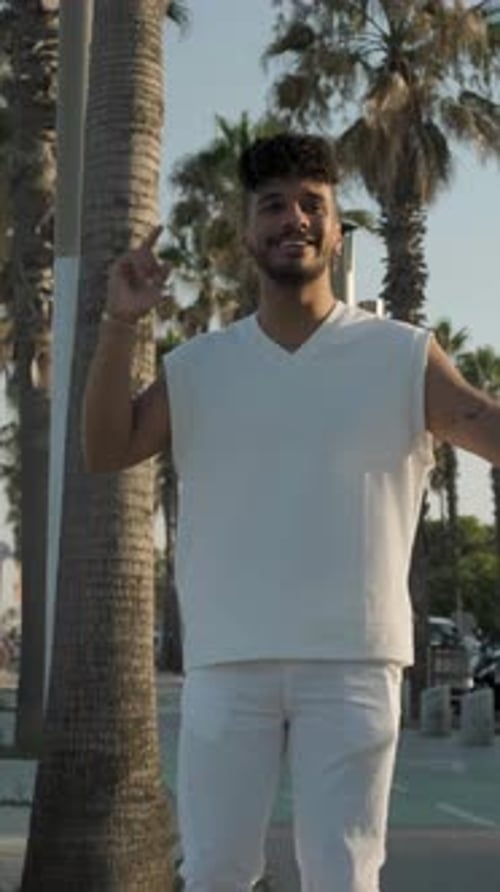 Joyful Afro Man Smiling While Enjoying Dancing Bachata Outdoors on the Street