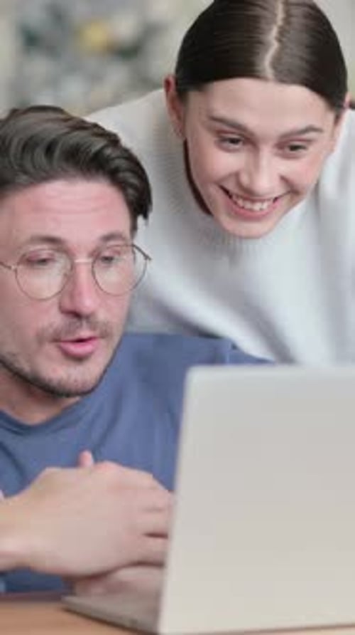 Happy Couple Video Calling on Laptop at Home