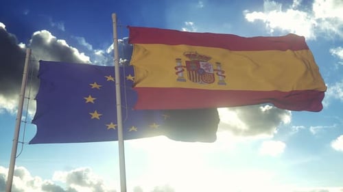 EU and Spanish Flags Waving Together Under Sunny Sky