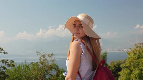 Young Woman Traveler Posing Overlooking Beautiful Ocean Vista