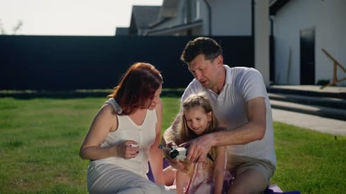 Happy Family Assembling Drone on Lawn Together