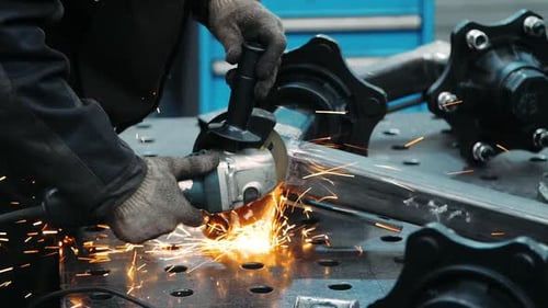 Factory Worker Polishing Seams After Welding with Angle Grinder. Angle Grinder In