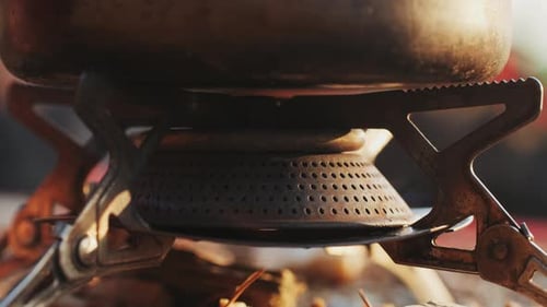 Pot Boiling on Camping Stove Outdoors