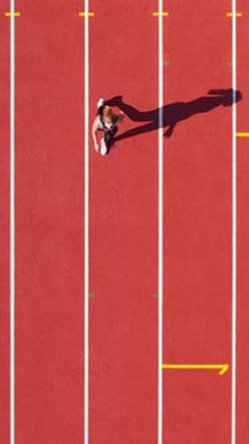 Birds Eye View of Woman Running on Track