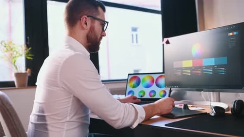 Man Designing Graphics in Modern Office Environment