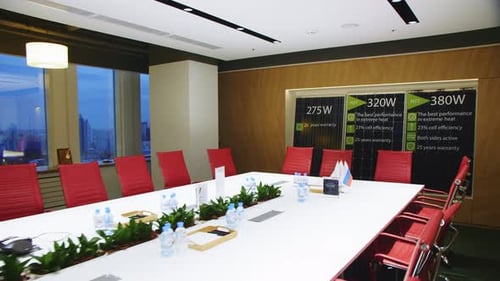 White Table with Red Chairs in Main Office Conference Hall