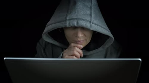 Adult in Hooded Sweatshirt Using Computer at Night