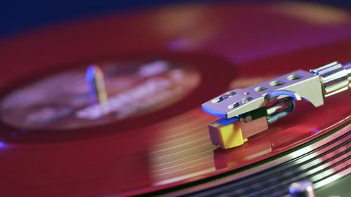 Vinyl Retro player turntable. Rotating red vinyl plate close-up.