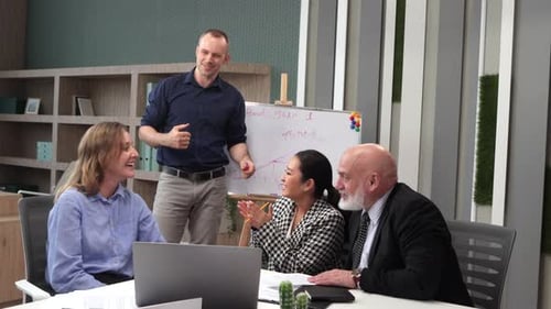 Successful Man Presenting His Idea to Colleagues Creative Office Workers