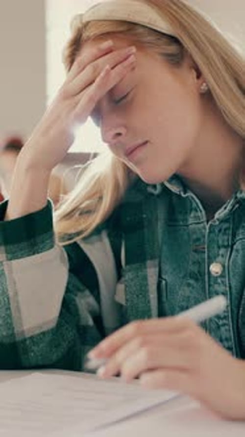 Stress, thinking and writing with student in classroom for academic pressure