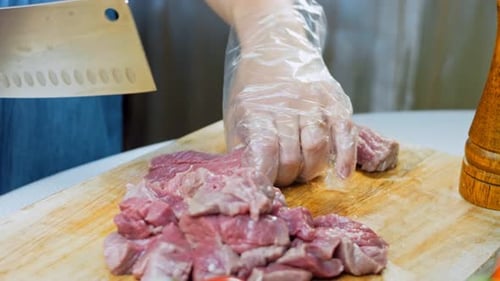 Cutting Raw Meat on Wooden Board