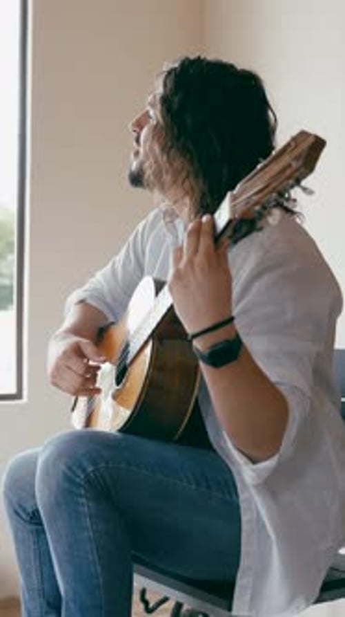 Passionate Musician Playing Acoustic Guitar and Singing