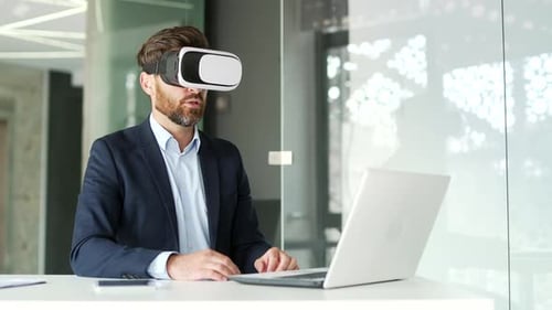 Man Using VR Headset at Desk