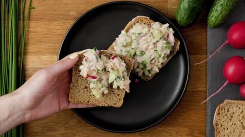 Fresh Open-Faced Sandwich Being Assembled With Radishes