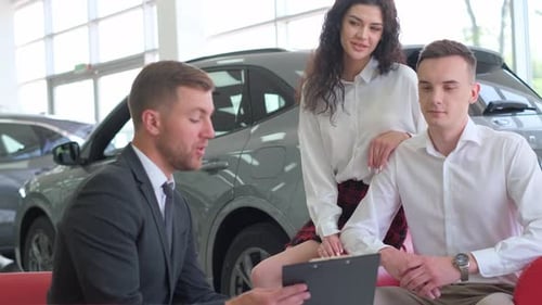 Young Couple Buying New Car at Dealership