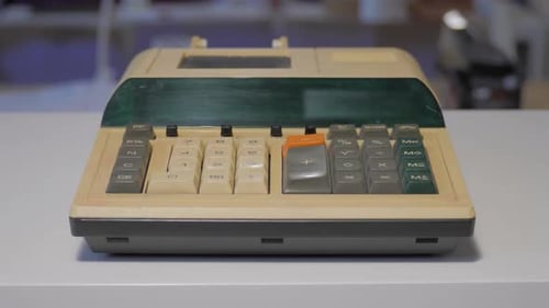 Close Up of Antique Calculator on White Surface