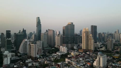 Aerial View of Bangkok City Skyline Under a Clear Blue Sky