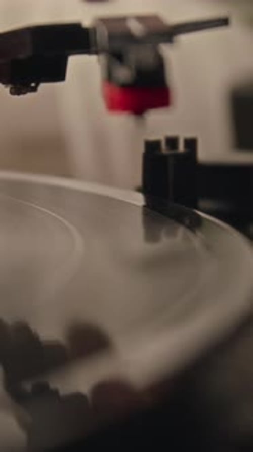 Vertical Close-up of Male Hand Putting Turntable Stylus on Record