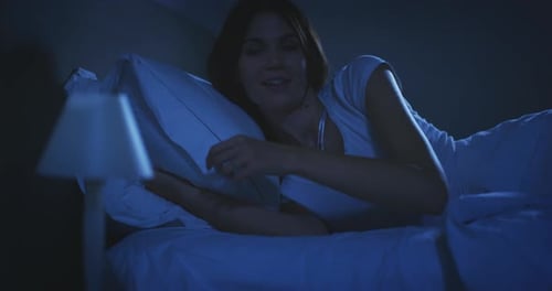 Woman Turning Off Light and Going to Sleep