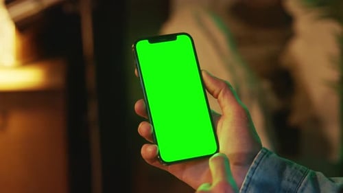Shot of Hands Using Typing on Mobile Phone with a Vertical Green Screen Indoors Social Media