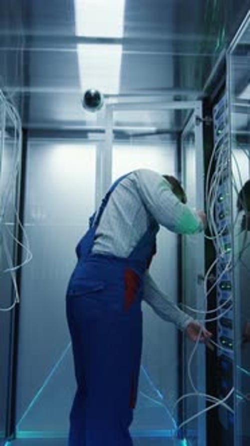 Male Technician Working in a Data Center