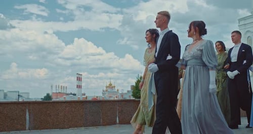Beautiful Women in Elegant Dresses with Lace Walk Through the Ukrainian City with Men in Tailcoats