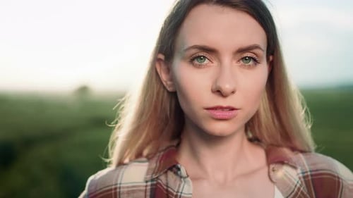 Portrait of Young Woman in Green Field