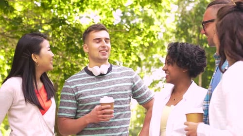Friends Talking and Drinking Coffee in Green Park