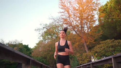 Middle Age Woman Jogging in City Park