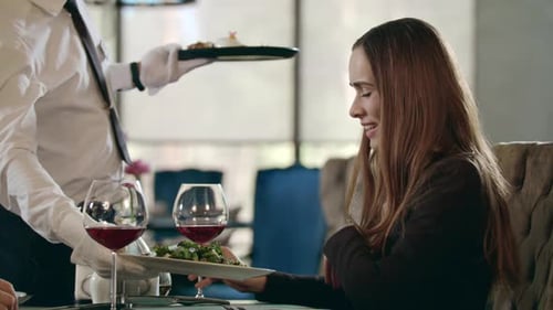 Businesswoman Getting Ordered Food in Restaurant. Waiter Serving Meal for Business Woman