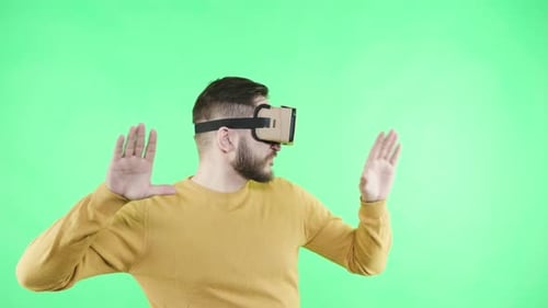Man Wearing VR Headset Gesturing on Green Screen
