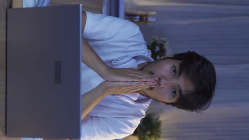 Surprised Young Adult Looking at Laptop at Night