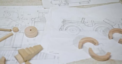 Technical Drawings and Wooden Toy Parts Composition