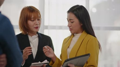 Corporate Team Discussing Digital Strategy in Modern Office