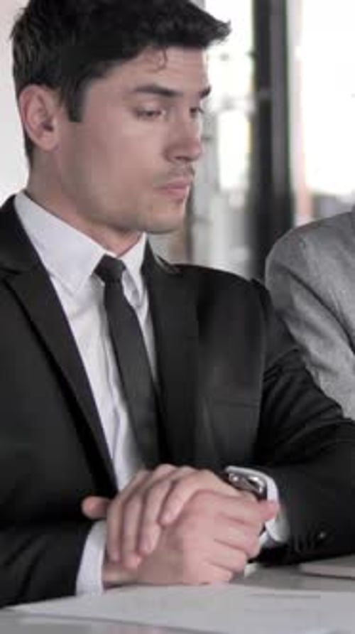 Man in Suit Discussing Business in Office