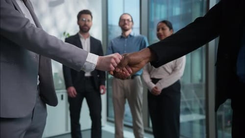 Close Up Handshake Two Businesspeople Shaking Hands Background of Office Multiethnic Workers