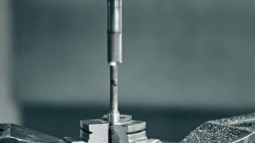 Metal drilling machine in action on workpiece in closeup view