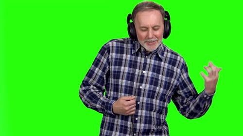 Enthusiastic Man Wearing Headphones Plays Air Guitar