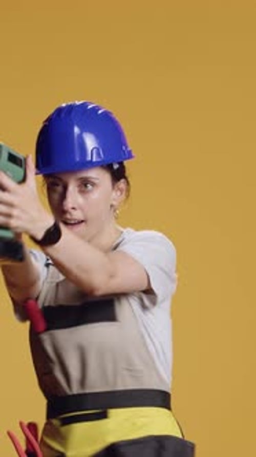 Vertical Video Construction Worker Having Fun with Power Drill Machine