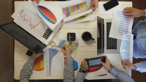 Group of Young Entrepreneurs Plan Future Project Sitting at Table