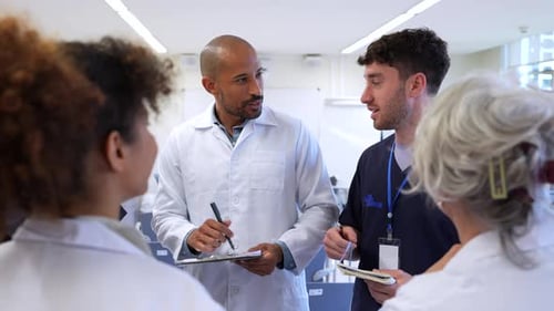 Medical Team Discussing Patient Cases in Hospital Meeting