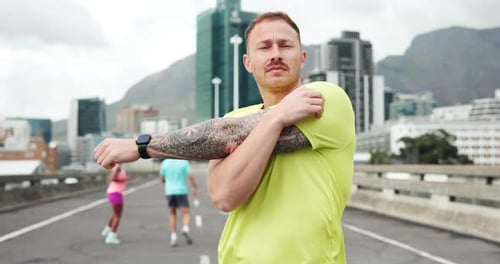Stretching arms, runner and man in city for exercise, marathon training and workout outdoor