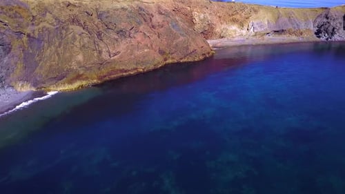Flying over cliffs to reveal the Atlantic ocean and a beautiful coastline